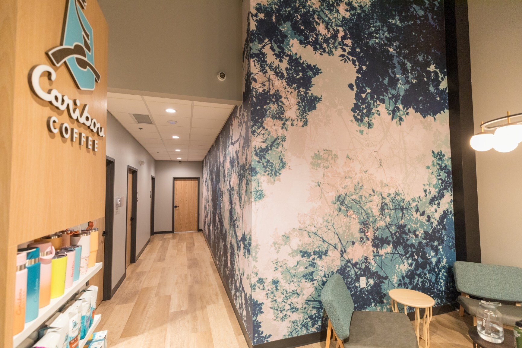 Interior of Caribou Coffee showing hallway, seating area, and branded wall design, constructed by Rice Companies