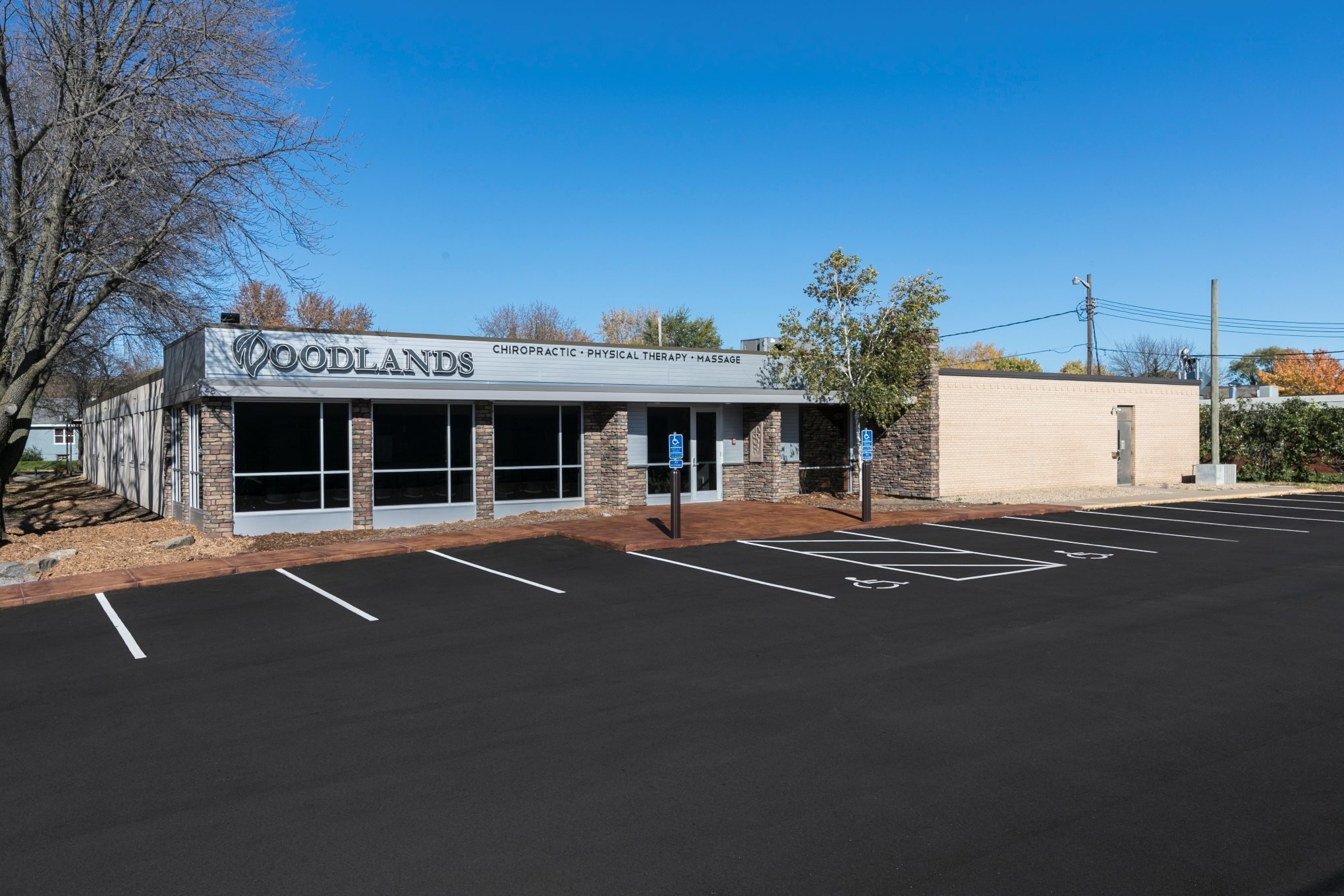 Exterior of chiropractic clinic showing updated building and parking lot, constructed by Rice Companies