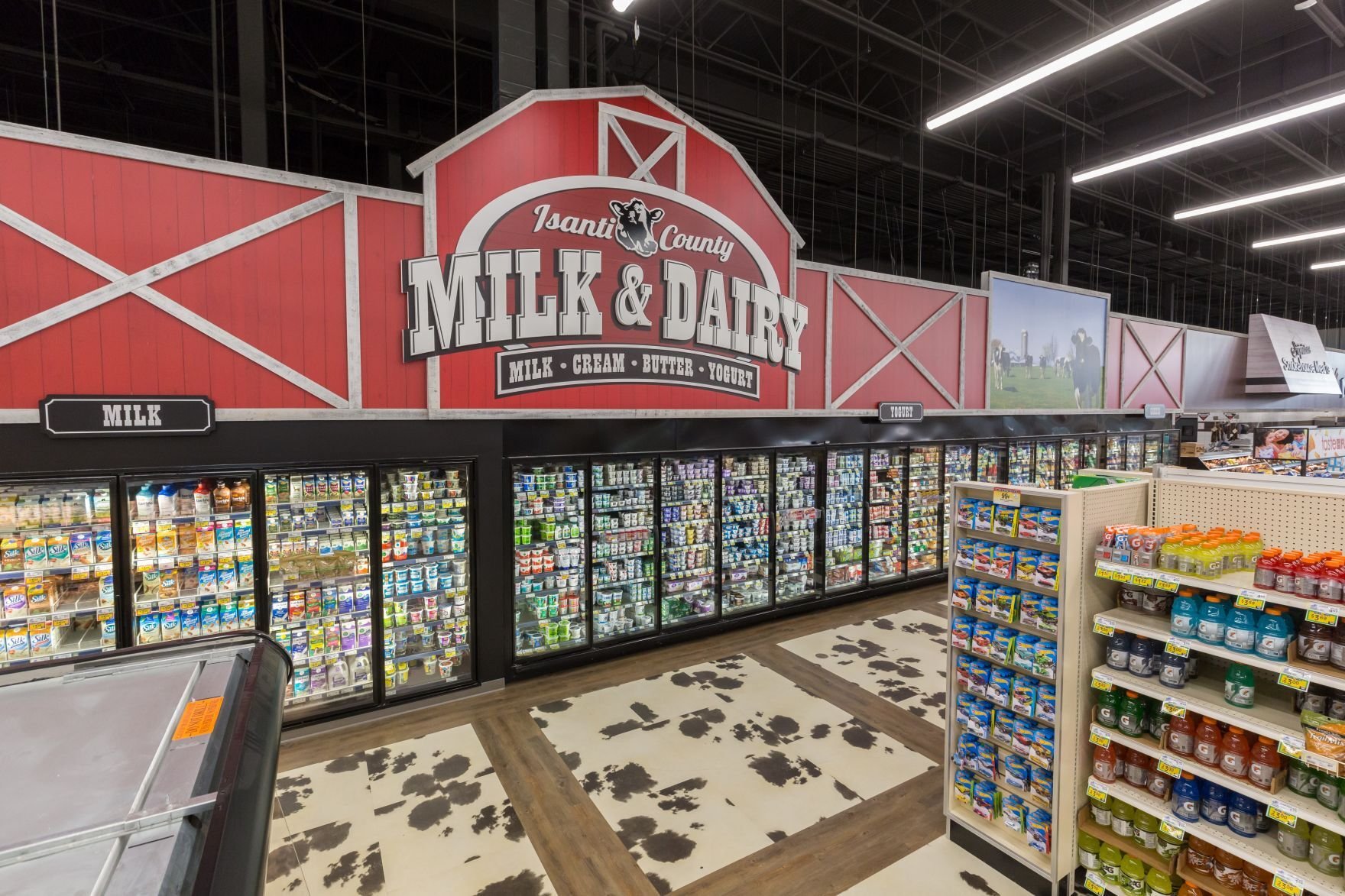Interior of grocery store featuring milk and dairy department with refrigerated cases built by Rice Companies