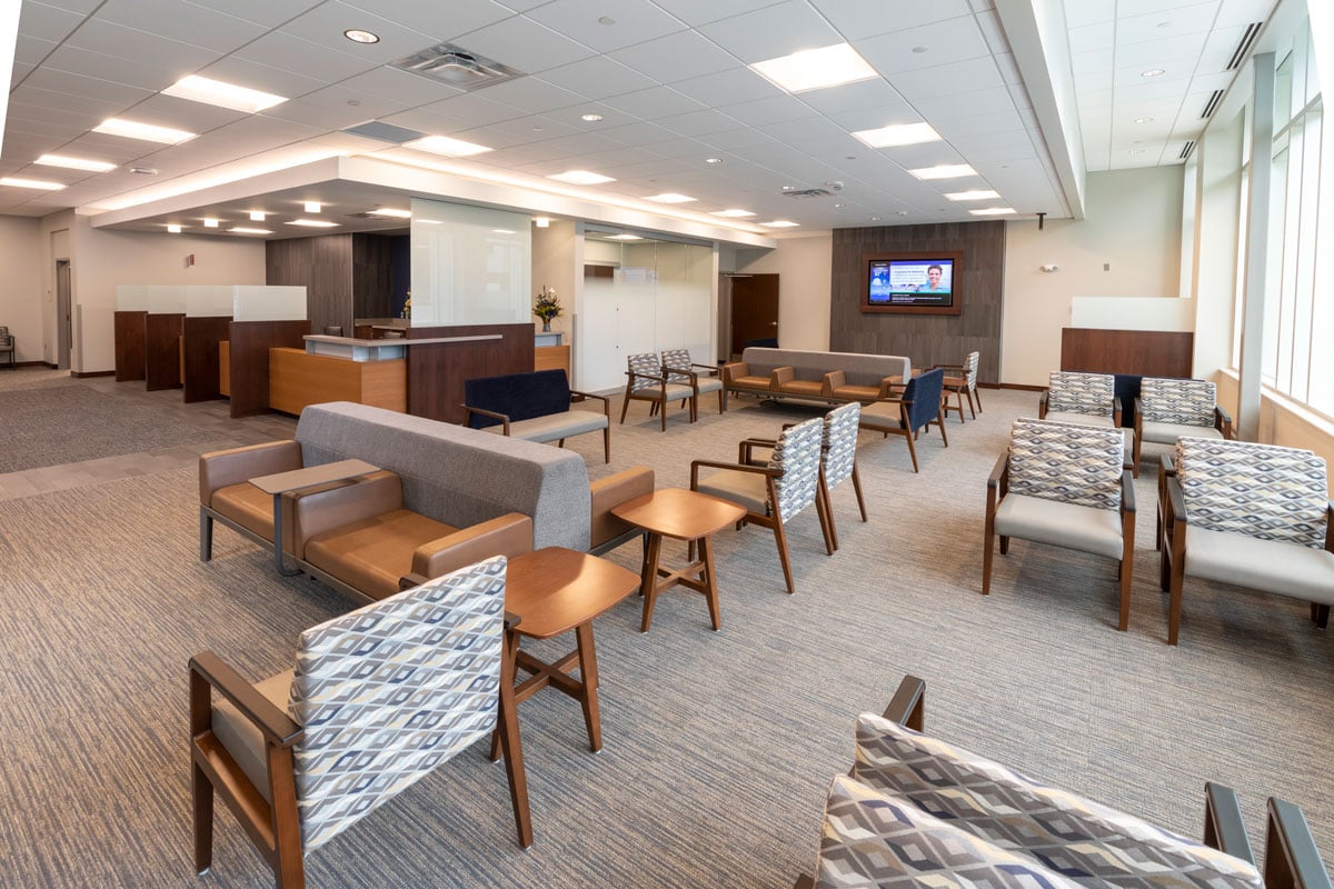 Interior of medical clinic showing patient waiting area and reception desk, constructed by Rice Companies