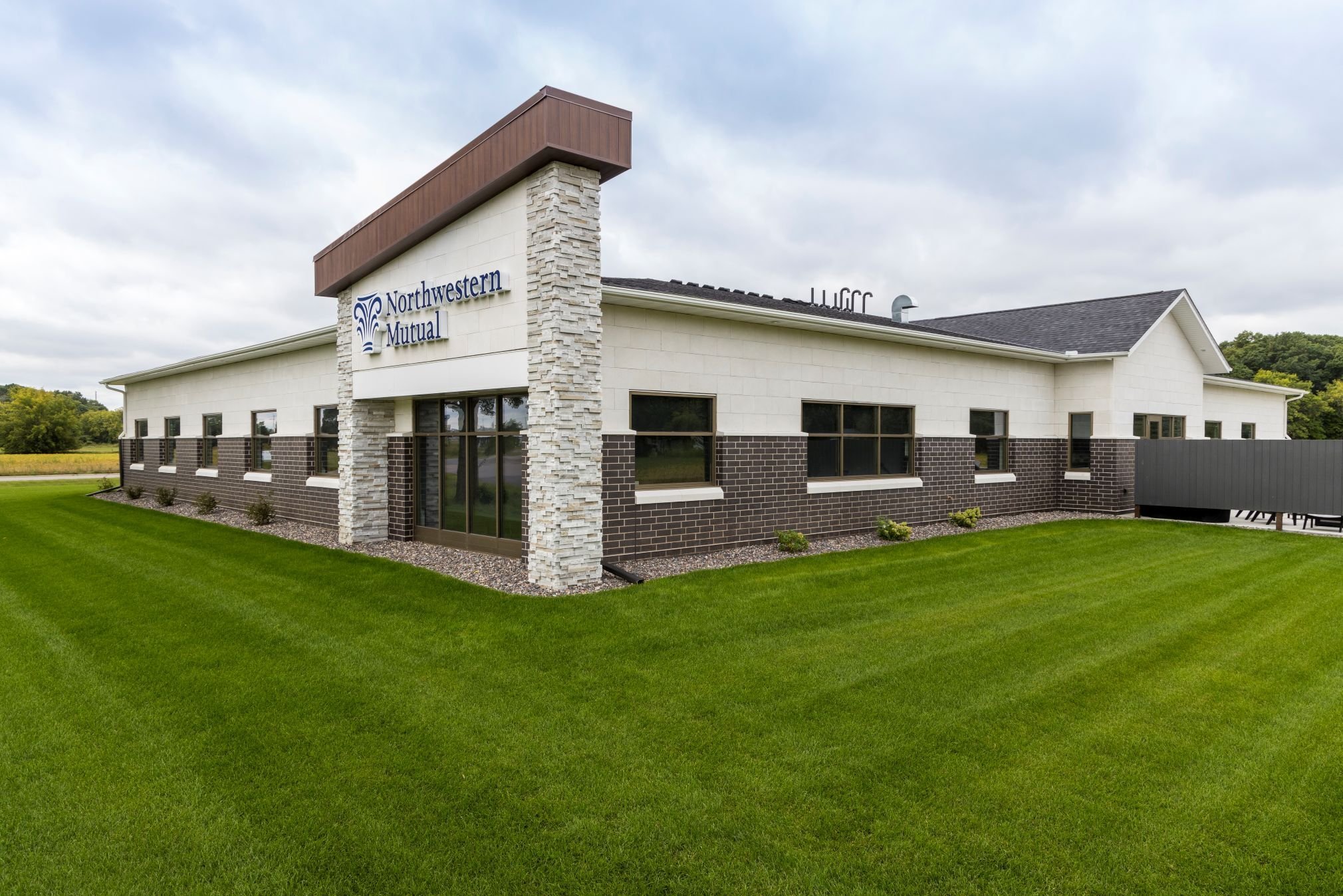 Exterior of corporate office building showing stone accents and landscaped site, constructed by Rice Companies