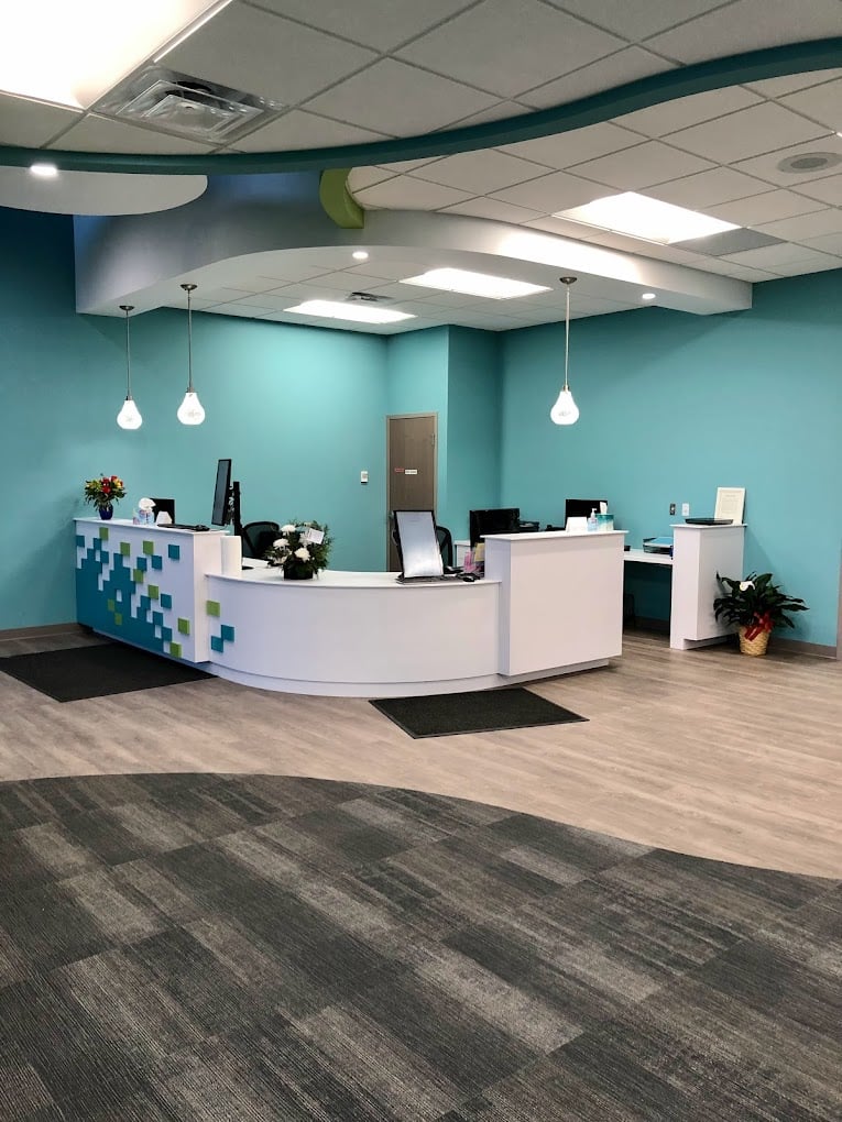 Interior of pediatric dental clinic showing reception desk and waiting area, constructed by Rice Companies