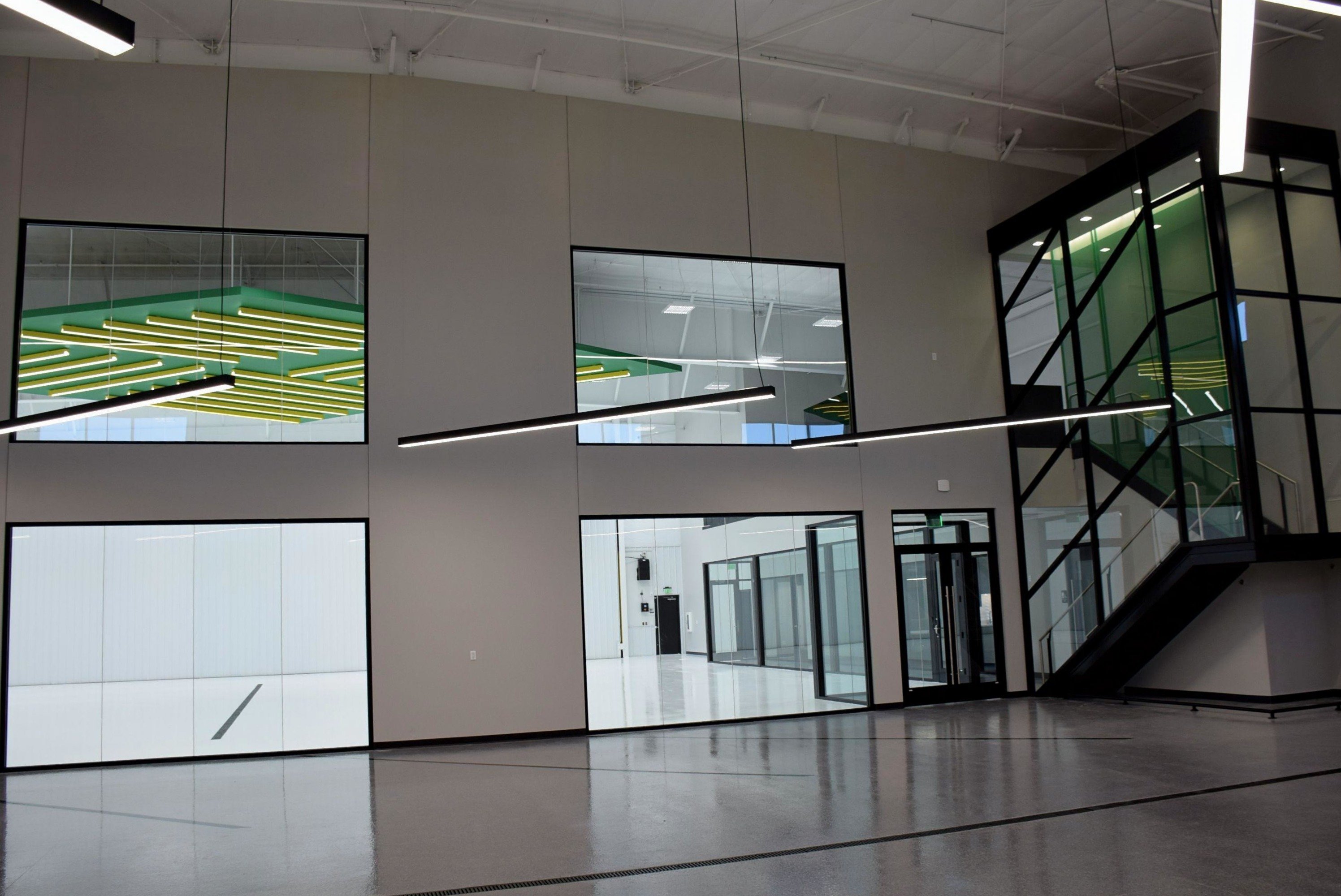 Interior of aircraft hangar facility showing office space and mezzanine level, constructed by Rice Companies