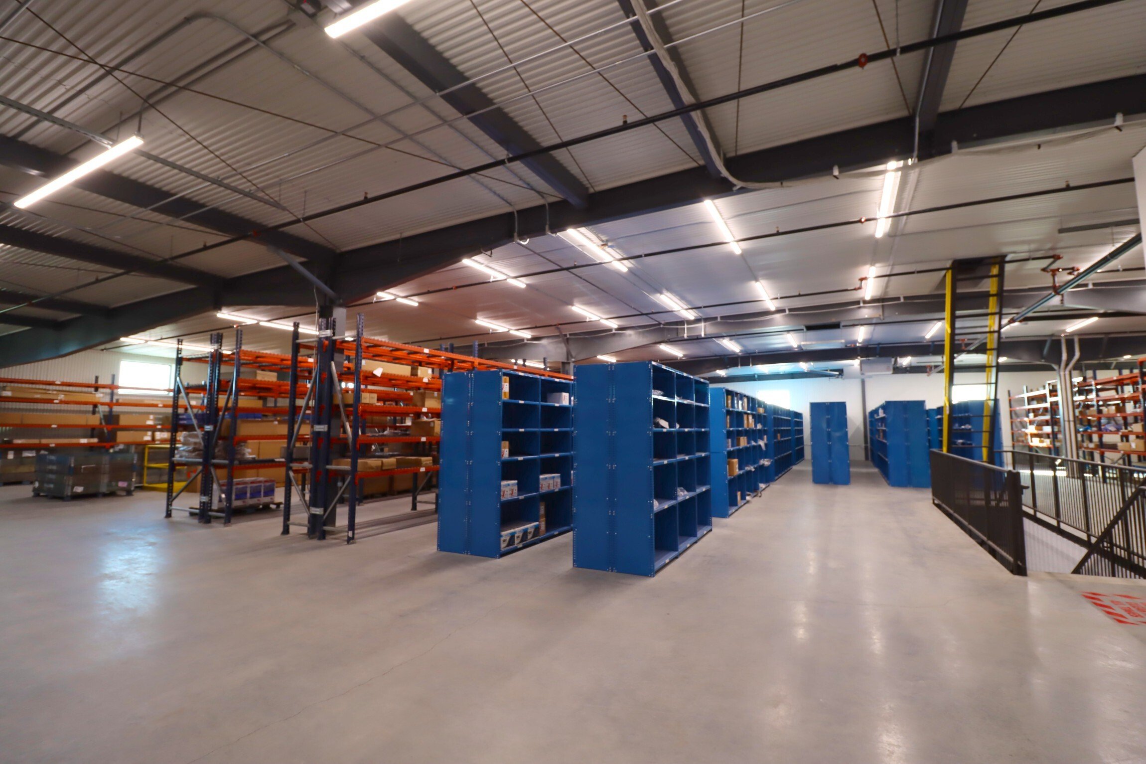 Interior of industrial service facility showing warehouse storage and parts shelving, constructed by Rice Companies
