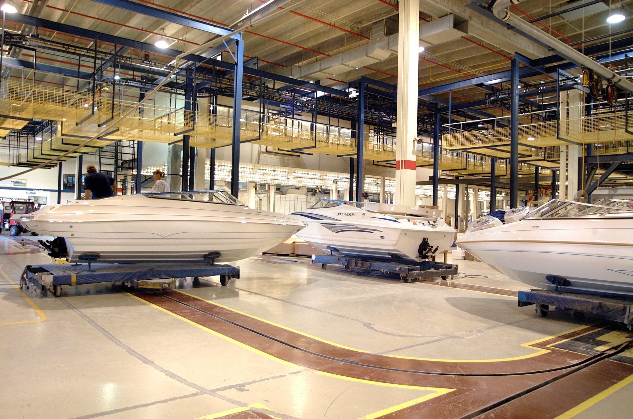 Interior of marine manufacturing facility showing high-bay assembly space and overhead material systems, constructed by Rice Companies