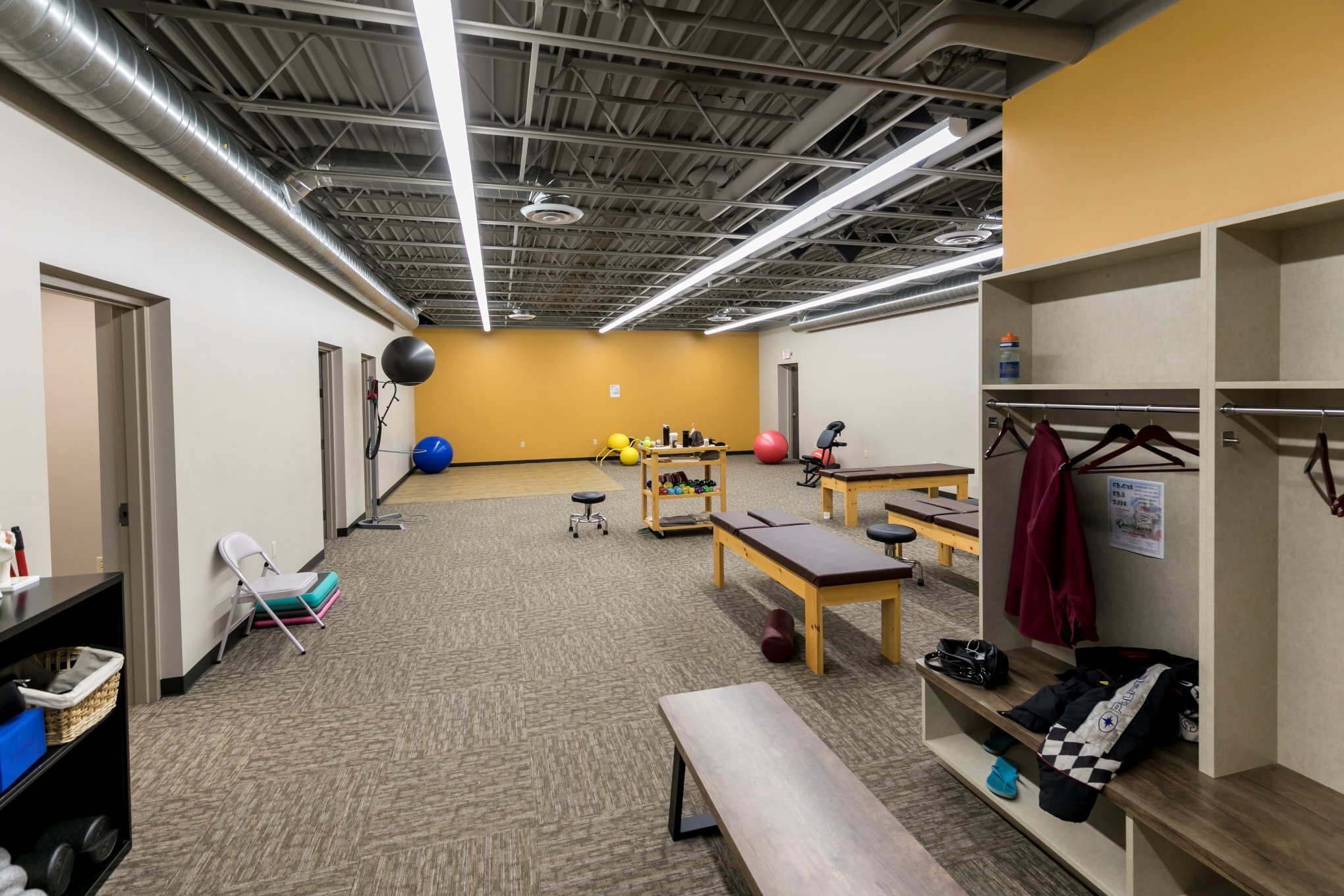 Interior of physical therapy clinic showing open treatment space and therapy equipment, constructed by Rice Companies