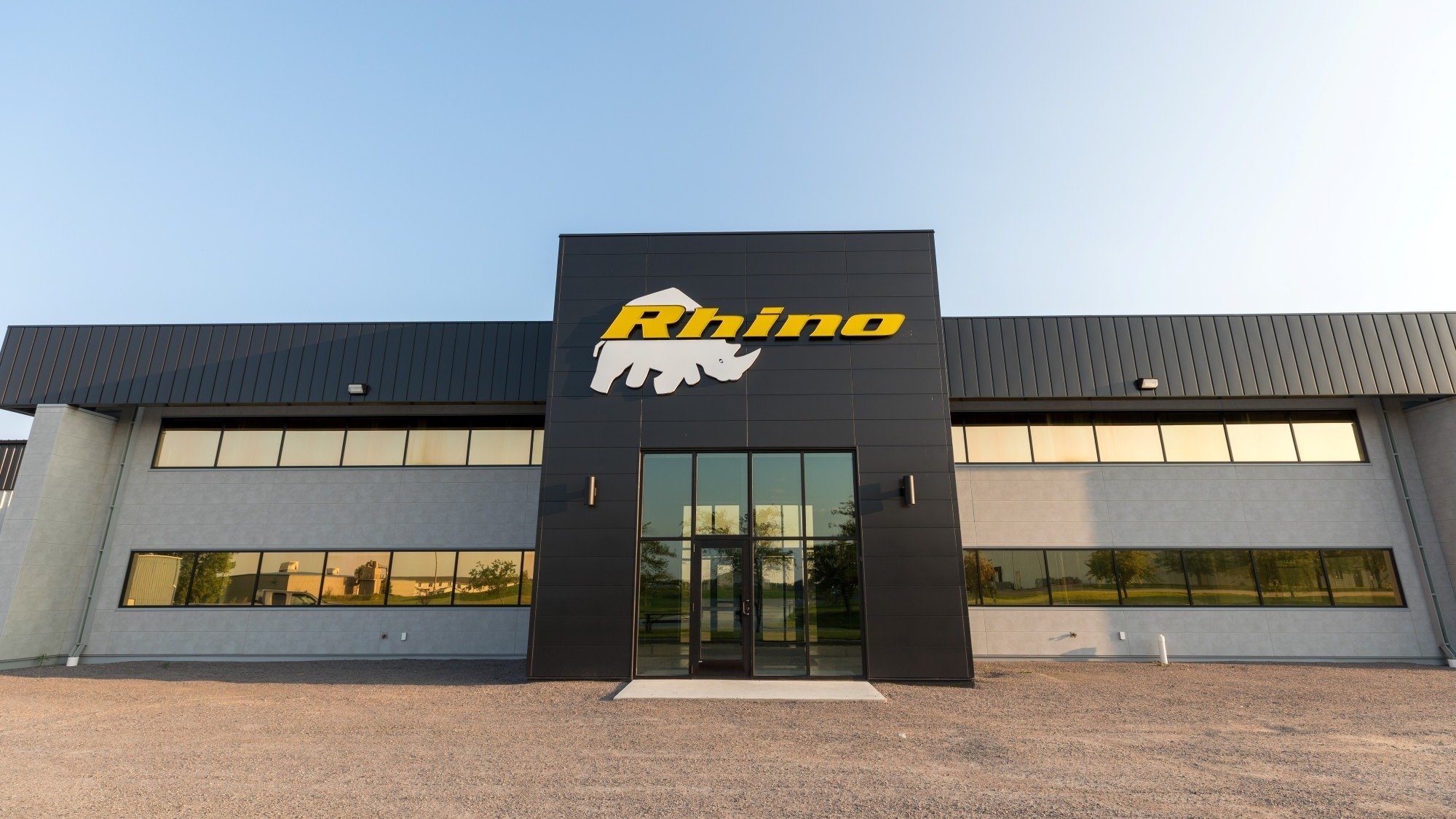 Exterior of manufacturing facility showing branded facade and main entrance, constructed by Rice Companies