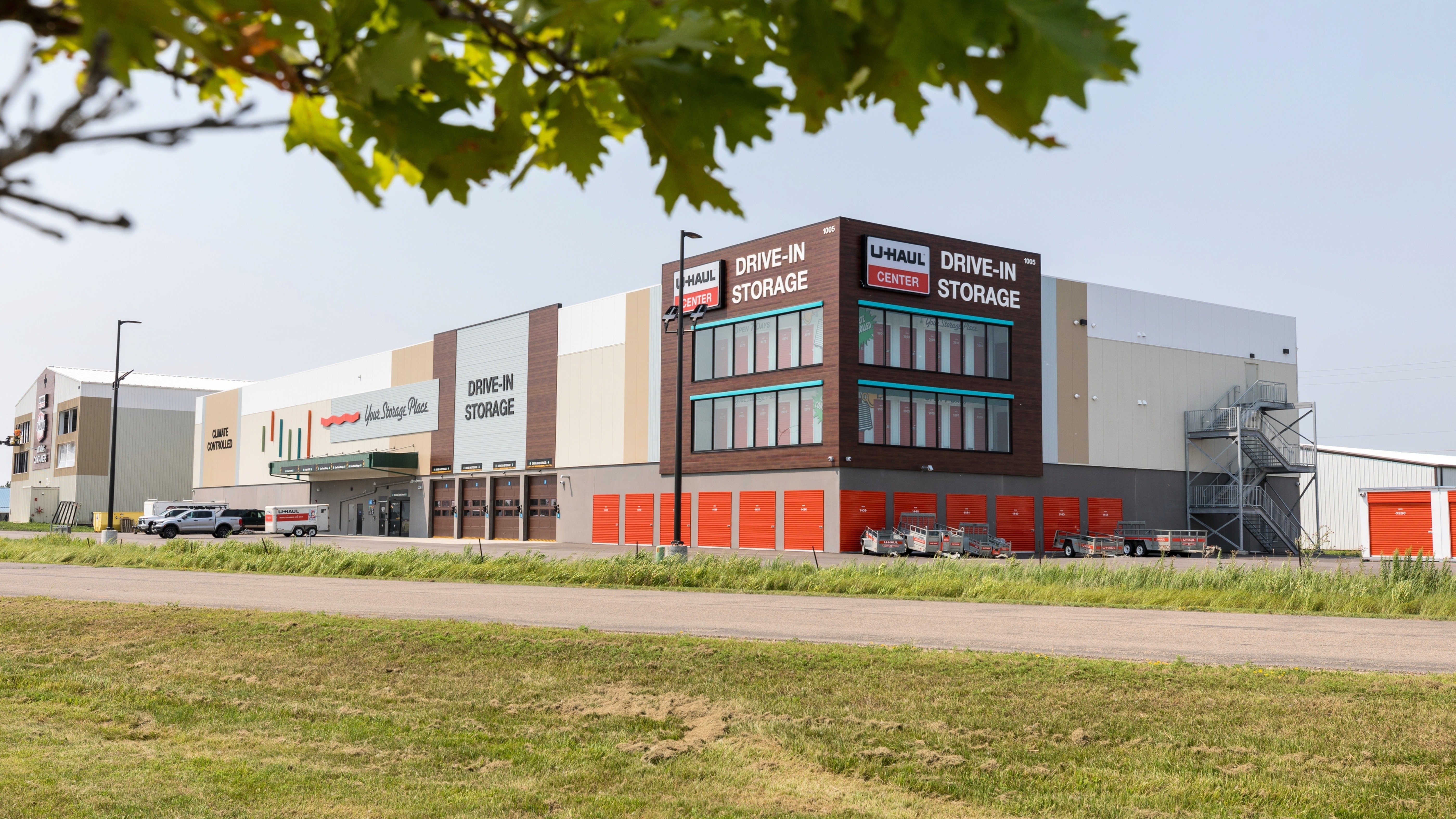 Wide exterior view of U‑Haul drive‑in storage facility with multi‑level units and loading bays, constructed by Rice Companies