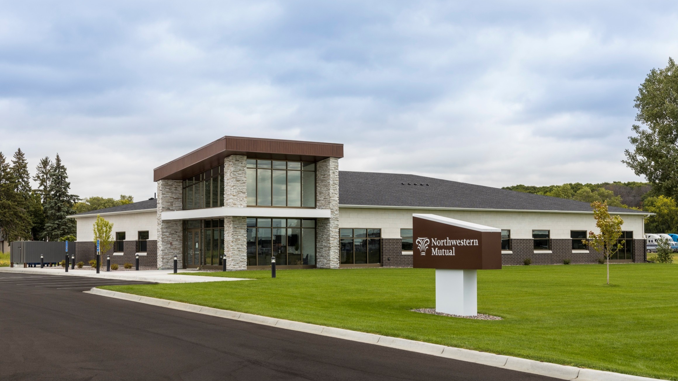 Exterior of corporate office building with stone entry tower and glass storefront, constructed by Rice Companies