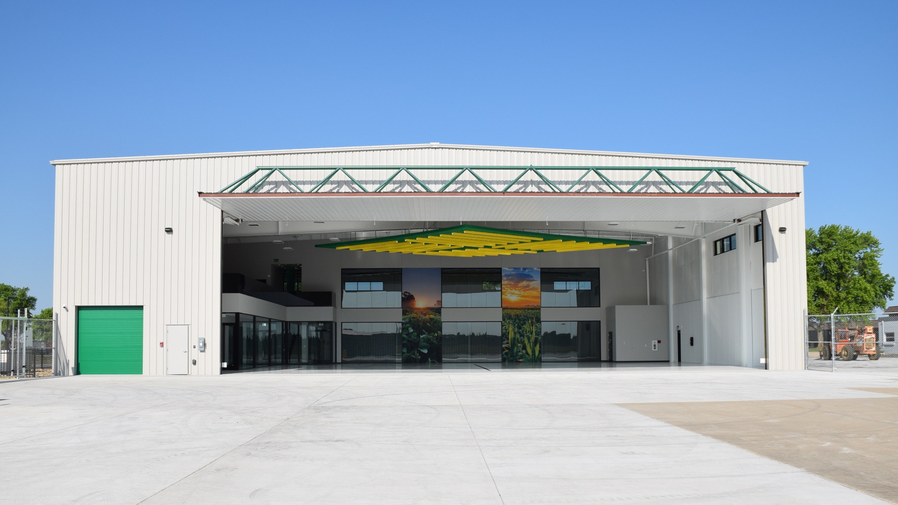 Exterior of aircraft hangar facility showing custom hangar door and apron access, constructed by Rice Companies
