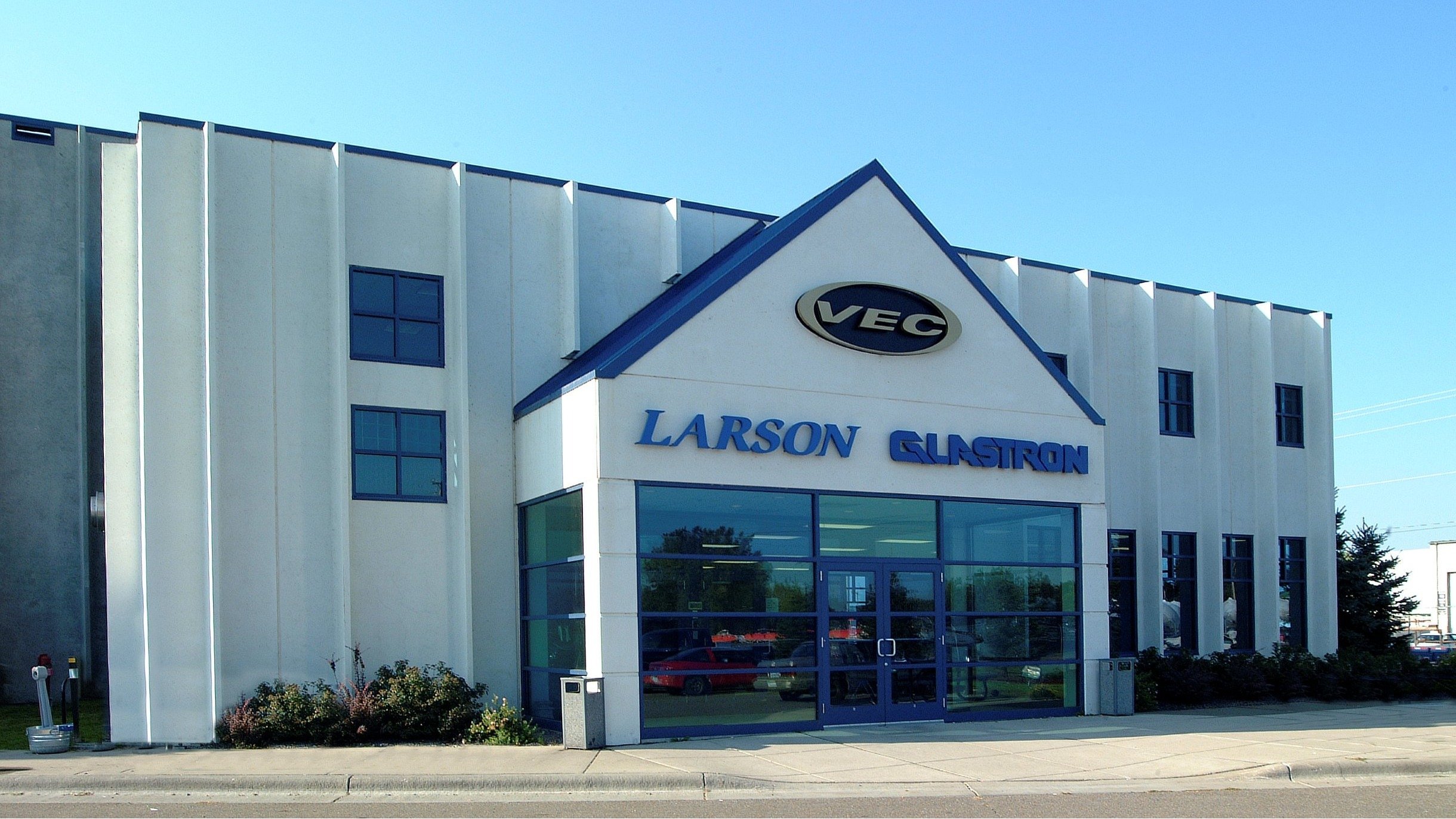 Exterior of marine manufacturing facility with branded entrance and glass storefront, constructed by Rice Companies